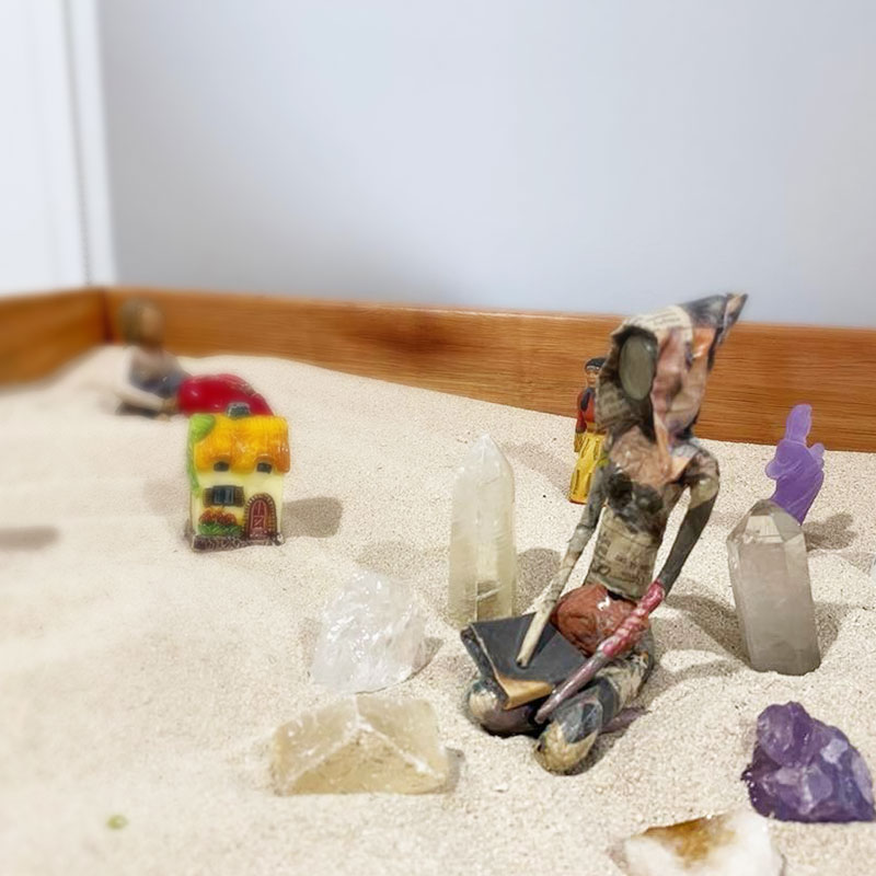Sandplay therapy in practice — miniature symbols and figures in a sand tray