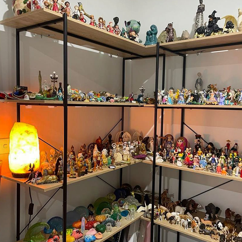 A contemplative sandplay scene with symbolic figures and natural objects